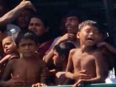 Hungry children packed on a fishing trawler off Thailand this afternoon