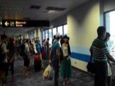 Passengers stream off the bomb scare flight at Phuket airport today