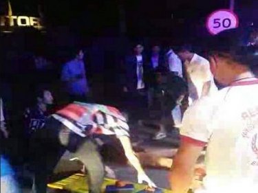 Paramedics treat the woman at the scene of the Phuket City crash