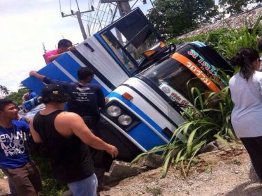 The crash scene as the Phuket-Hat Yai bus flips in Krabi today