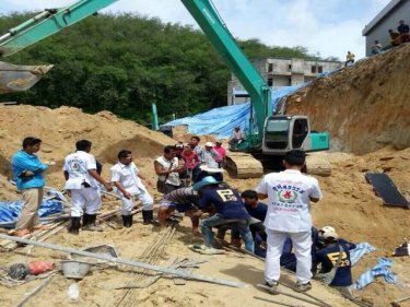 Rescuers struggle to free the six Patong workers buried in today's landslip