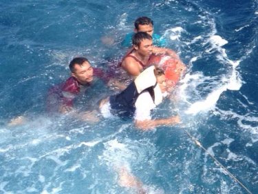 Crew from the fishing boat are rescued by the HTMS Chonburi today