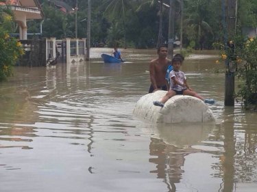 Children enjoy the fun of a flood that isolated 50 homes on Phuket