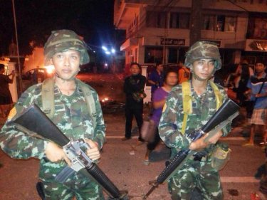 Armed troops quelled a riot and freed besieged Phuket police early today