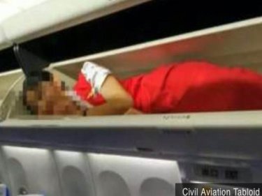 A member of the crew for a Chinese airline follows an ''industry ritual''