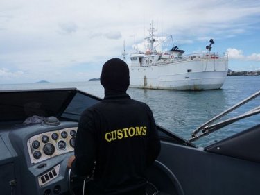 A Customs vessel inspects the captive Taishan off Phuket