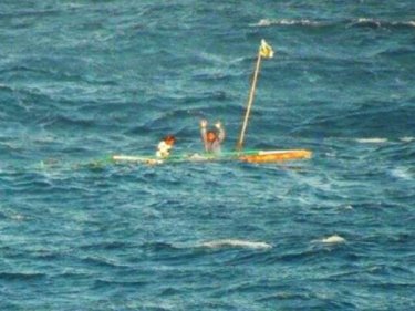 Fishermen desperately try to attract attention on a barely-floating raft
