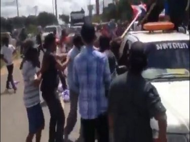 Protesters exchange blows in the street near Krabi airport this afternoon