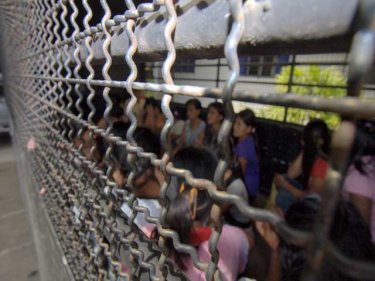 Female survivors from the April 9 container suffocation that killed 54. The women arrive at Ranong Immigration after being trucked from jail on April 20