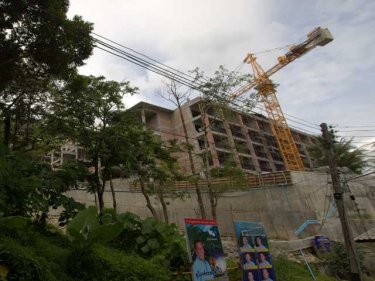 Construction proceeds on the hill behind Blue Marine in Patong