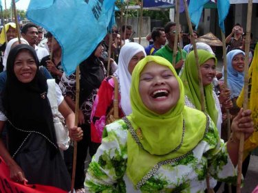 Women among the parade by fisherfolk through Phuket City today