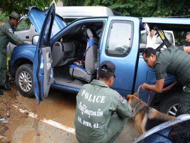 Police thoroughly search a vehicle at Ao Po, on Phuket's east coast