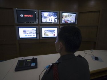 An officer watches screens at Phuket City police headquarters