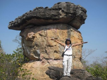 Man pretending to be an AirAsia flight at a Udonthani rock landmark
