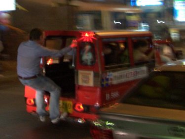 A tuk-tuk passenger enjoys New Year on Phuket . . . calls for lower fares