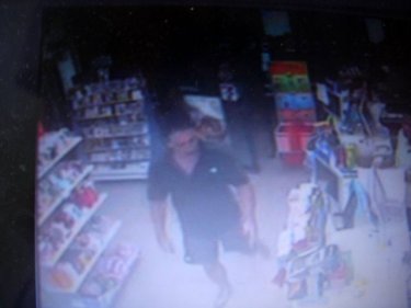 The man in black enters the Phuket 7-Eleven store and demands a knife