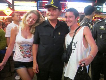 Phuket postcard: a happy couple pose with Governor Wichai in Patong