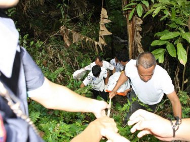 Foundation workers recover the body in the hills above Patong
