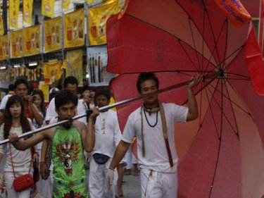 Unlikely to be shaded, Phuket's umbrella fella on parade today