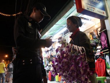A 76-year-old flower seller is arrested in Patong for touting in Soi Bangla