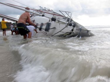 A yachtsman tries to save his vessel in vain at Phuket's Kata beach