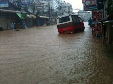 Patong early today as a tuk-tuk struggles to cope in water