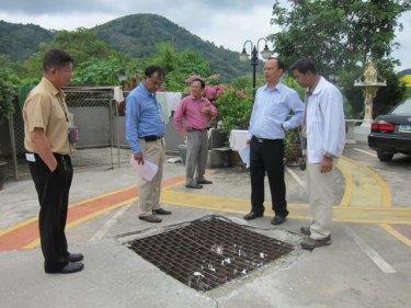 VG Somkiet (light blue) and officials check where the canal  once ran