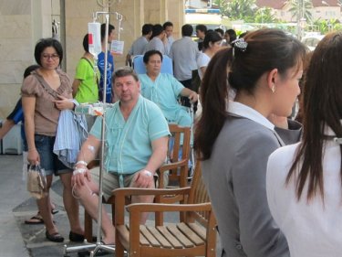 Evacuated patients outside Bangkok Hospital Phuket in Phuket City this afternoon