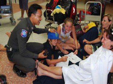 The long wait at Phuket's airport is made more bearable by s local officer