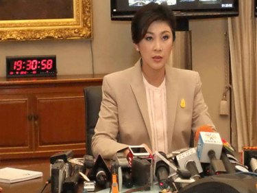PM Yingluck delivers her 8.30pm message with the telltale clock 