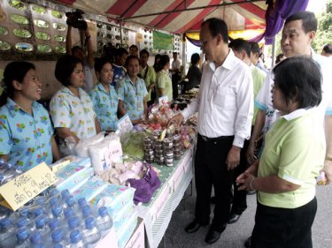 Phuket's Vice Governor Somkiet compares market prices yesterday