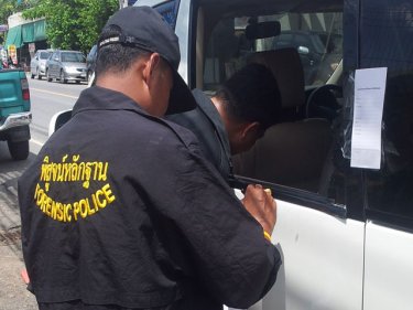 Forensic police check the scene of today's 30 million baht gems raid