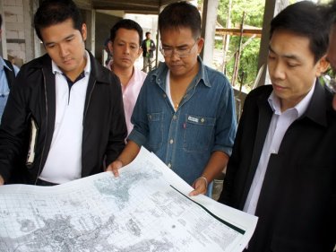 Officials check the land in the Karon hillside of Phuket yesterday