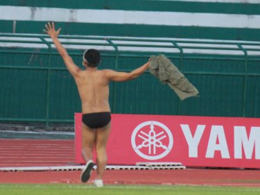 An almost naked Phuket fan celebrates the vital victory tonight