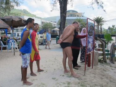 Tourists study a new Phuket jellyfish awareness station
