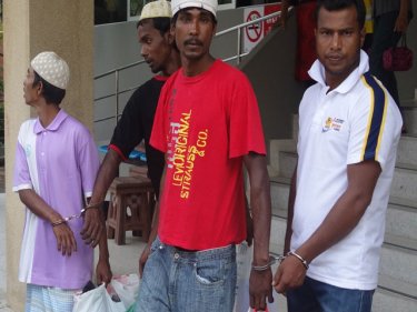 Handcuffed Rohingya headed for Phuket Immigration on February 22