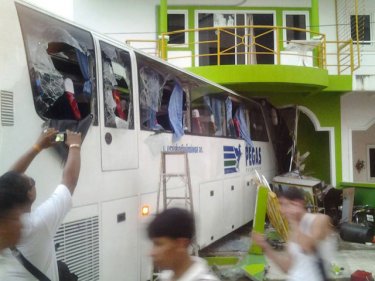 The crashed tourist bus impaled in the house in Patong this evening