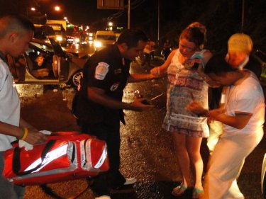 The pregnant woman is helped after last night's triple bypass crash