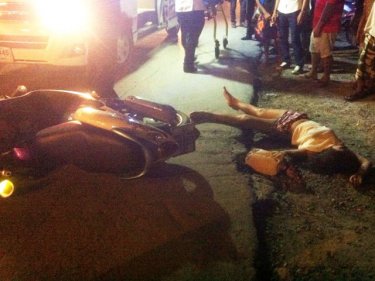 A woman lies on the road in Patong after a failed bag snatch today
