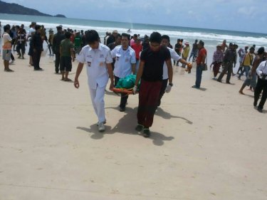 The man's body is carried from Patong beach this afternoon