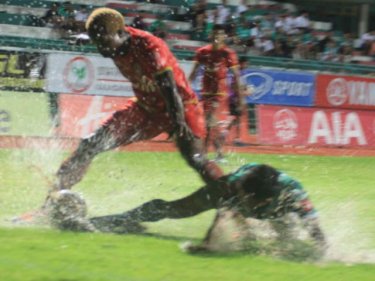 Giving them a bath: players on the wet surface as Phuket wins tonight