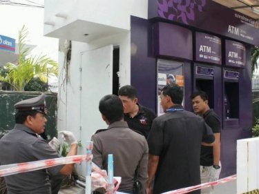 Police inspect the ATM after a heist that cost the bank 1.6m baht