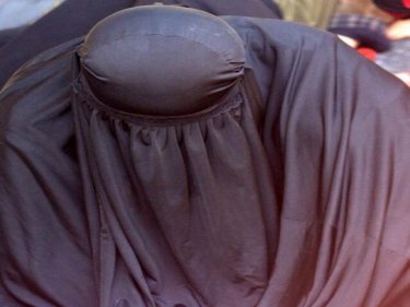 A woman hides as authorities try to determine the group's identity