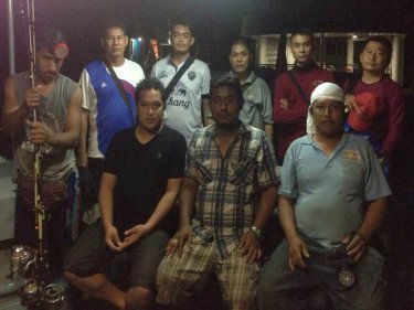 The fishermen and their rescuers after returning to Phuket early today