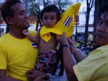 A sea of yellow marked a celebration as street protesters, many from Phuket, honored HM The King's coronation anniversary last night