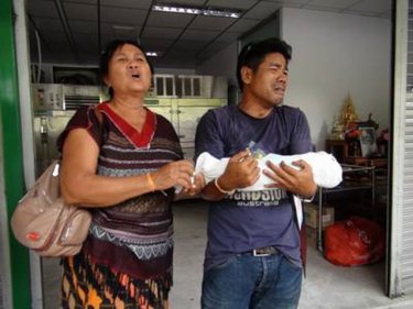 The body of the boy with his grieving family at Vachira Phuket Hospital yesterday