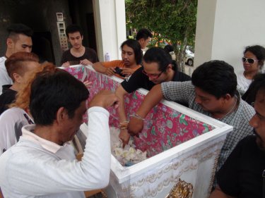 Mourners farewell a boy who died soon after his mother perished in childbirth