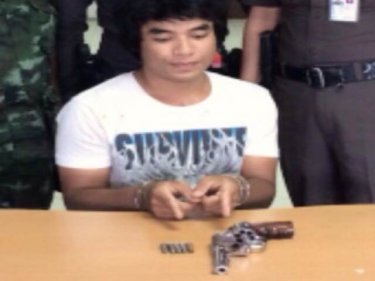 Gunman Chalong Kaitep, 24, in the hands of police yesterday afternoon