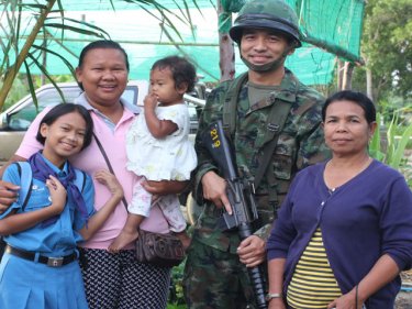 Residents and military are all smiles during today's Phuket dawn raid