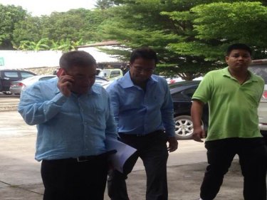 A Kata-Karon official surrenders at Phuket City Police headquarters today